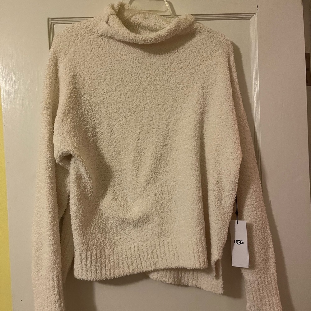Brand new ugg sweater with tags on it, cream colored